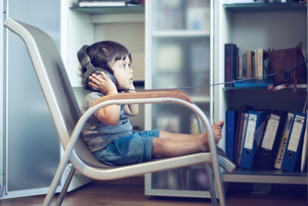 Child listening with headphones