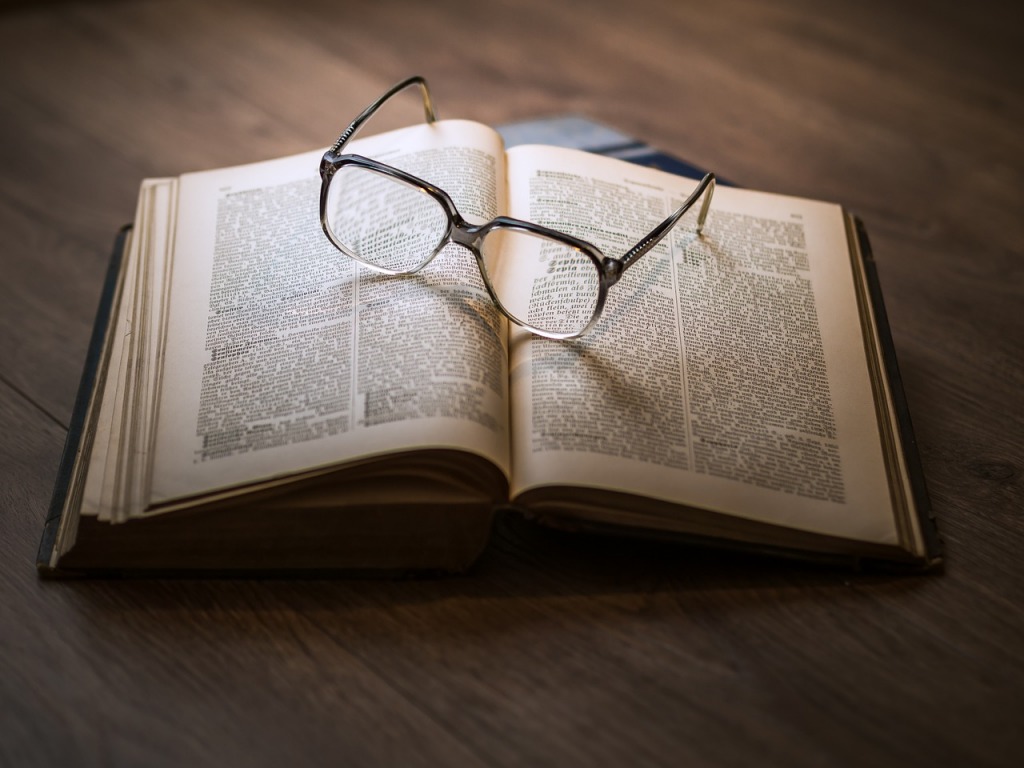Glasses resting on open book