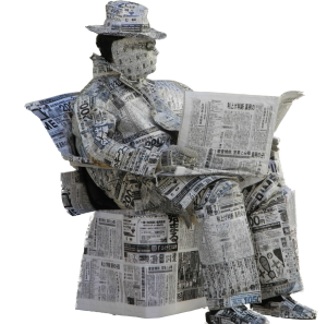 Sculpture of a man reading the newspaper, made of newspaper