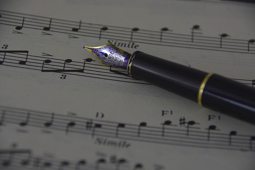 Fountain pen resting on sheet music
