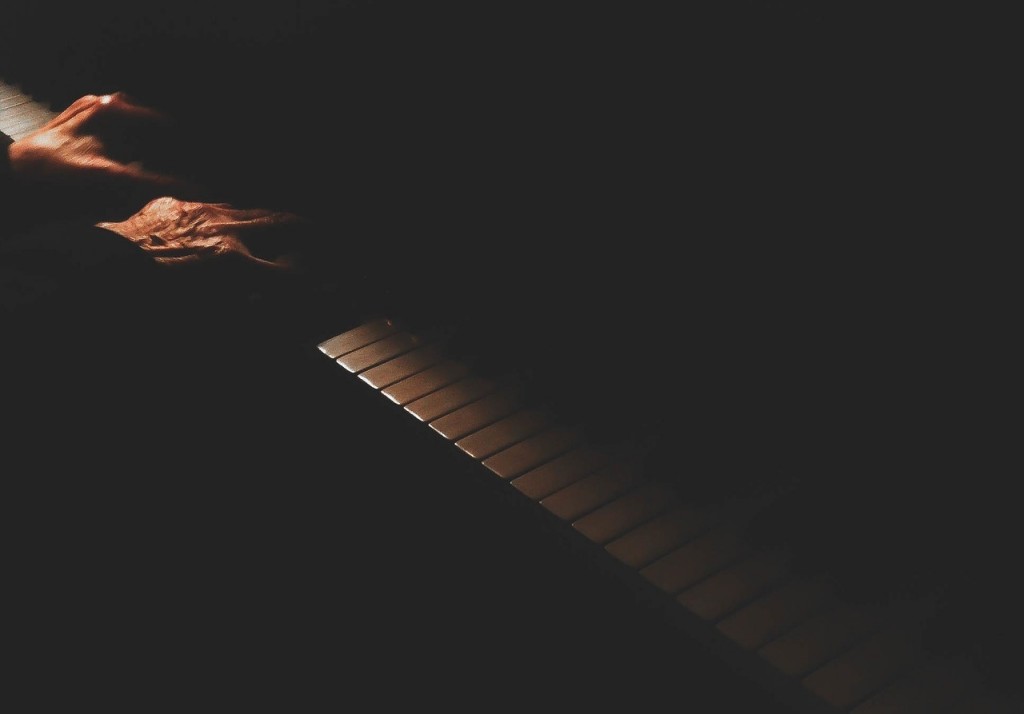 Pianist's hands on the keys in the dark