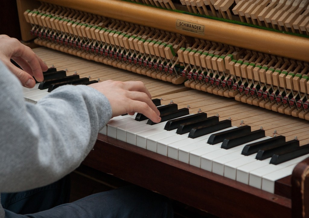 Upright piano with mechanism exposed