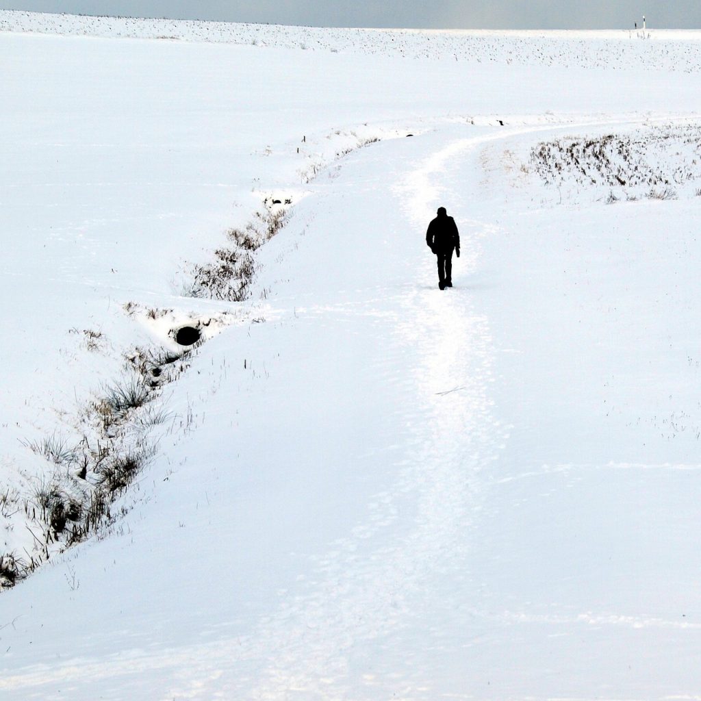 Man walking through the snow