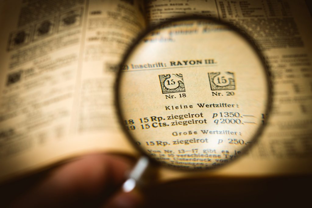 Magnifying glass over page of German text