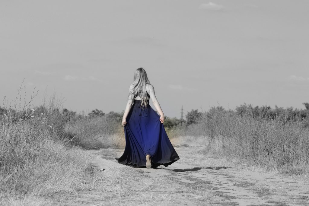 Girl in a dress walking on a path