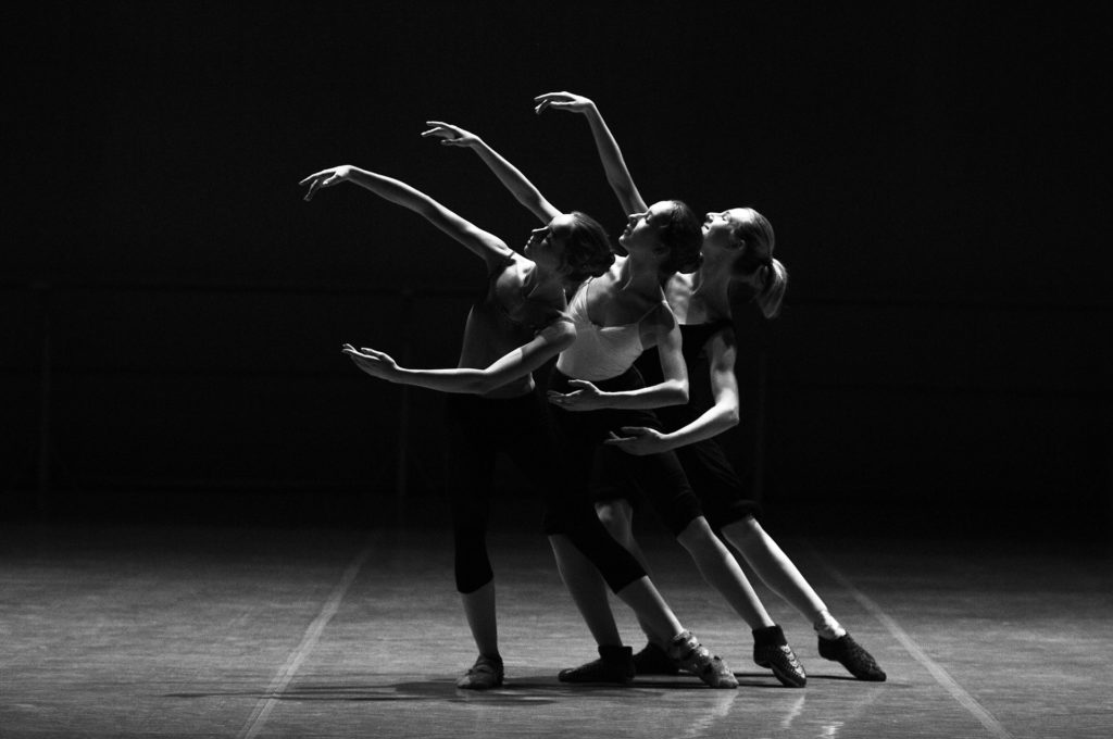 Three dancers rehearsing