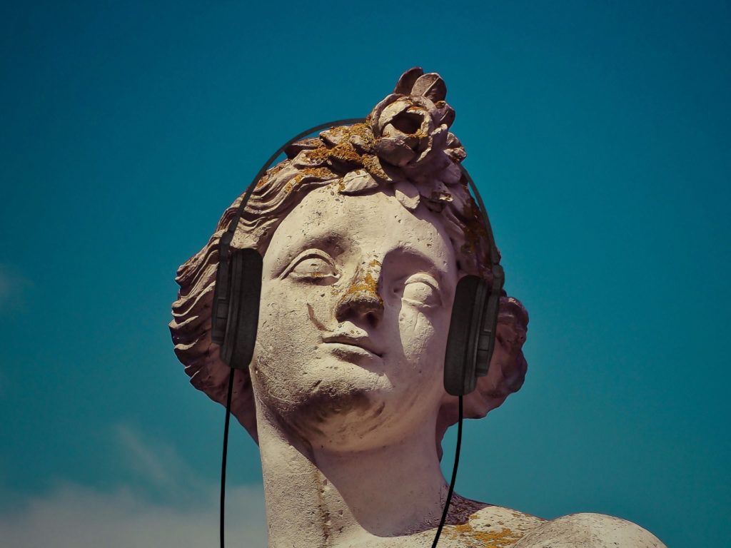 Classical statue wearing headphones