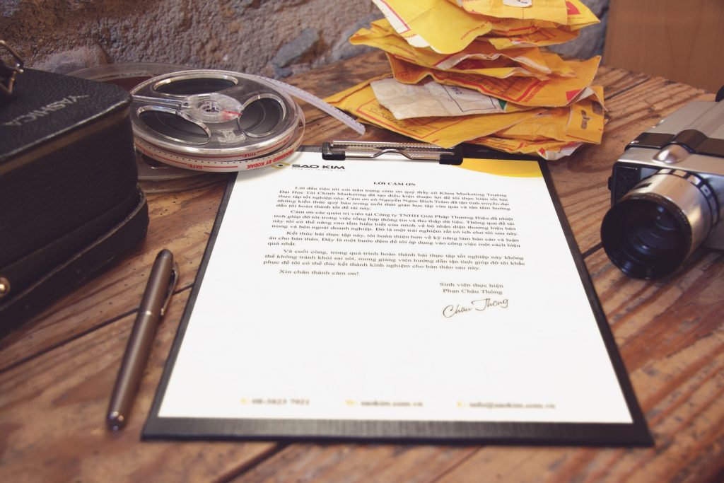 Clipboard with letter, camera and film reels