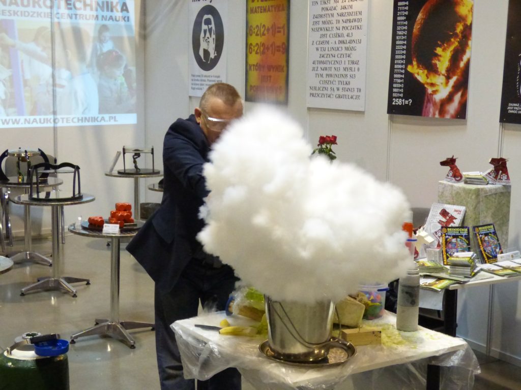 A scientist in a lab creating a smoke clouad