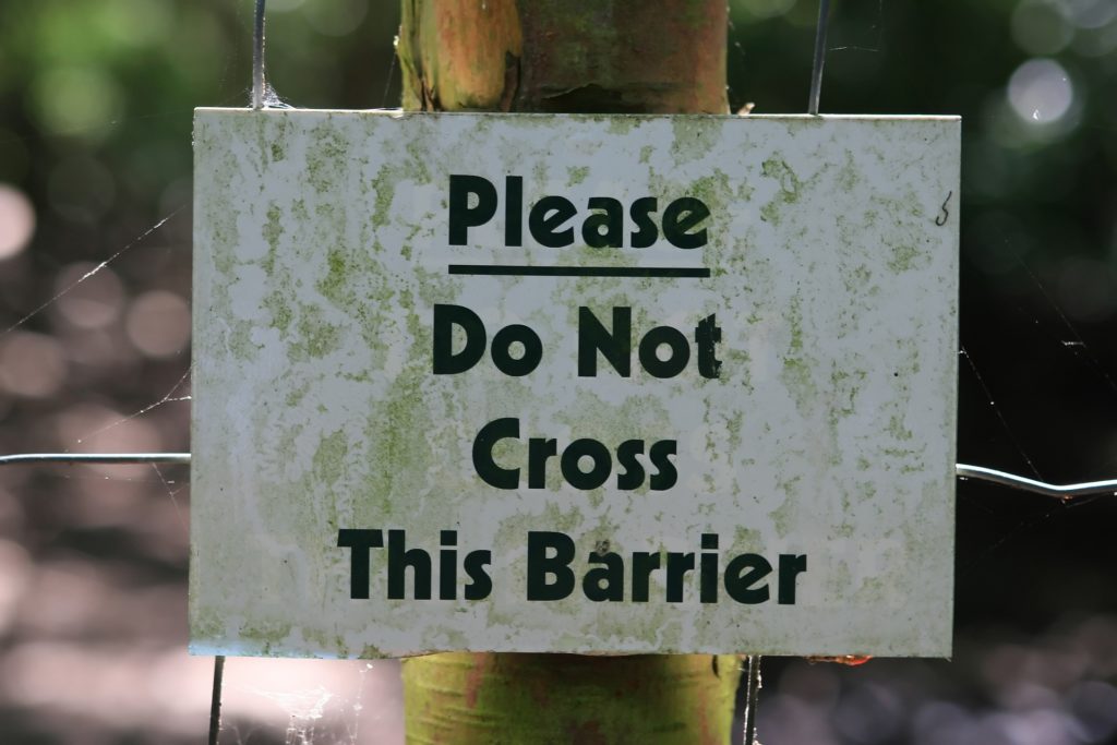 Sign, 'Please do not cross this barrier'